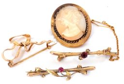 Mixed Lot: two 9ct stamped brooches, each highlighted with pink stones, a tied ribbon brooch, (