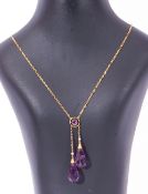 Yellow metal double drop amethyst necklace featuring two faceted amethyst drops, joined to a small