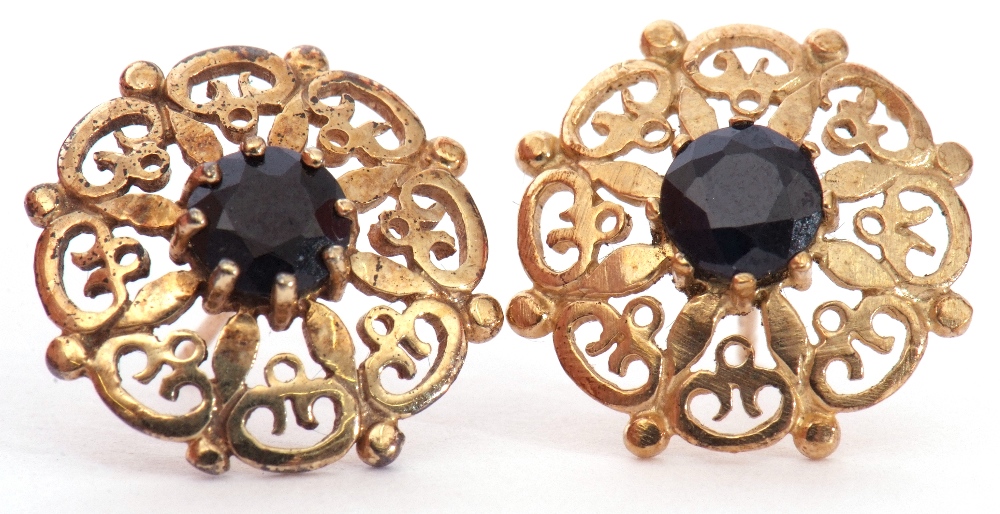 Pair of 9ct gold and sapphire earrings, the pierced shield shape design centring a round faceted