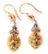 Pair of Victorian high carat gold drop earrings, the oval shaped drops applied with a chased and