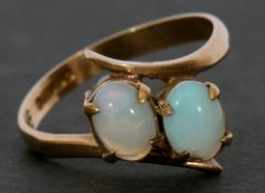 9ct gold and opal cross-over ring featuring two oval cabochon opals raised between plain polished