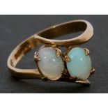9ct gold and opal cross-over ring featuring two oval cabochon opals raised between plain polished