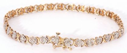 Diamond set line bracelet featuring 30 small diamonds, each in an illusion setting, joined by X-
