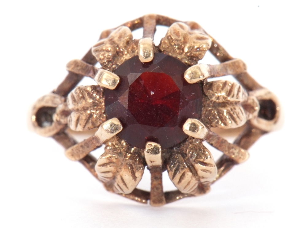 9ct gold and garnet ring centring a round faceted garnet, claw set in a pierced and engraved leaf - Image 2 of 7