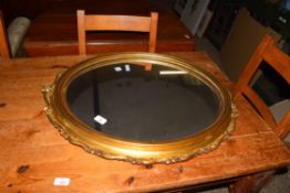 GILT FRAMED OVAL MIRROR WITH MOULDED DECORATION, APPROX 76 X 63CM MAX