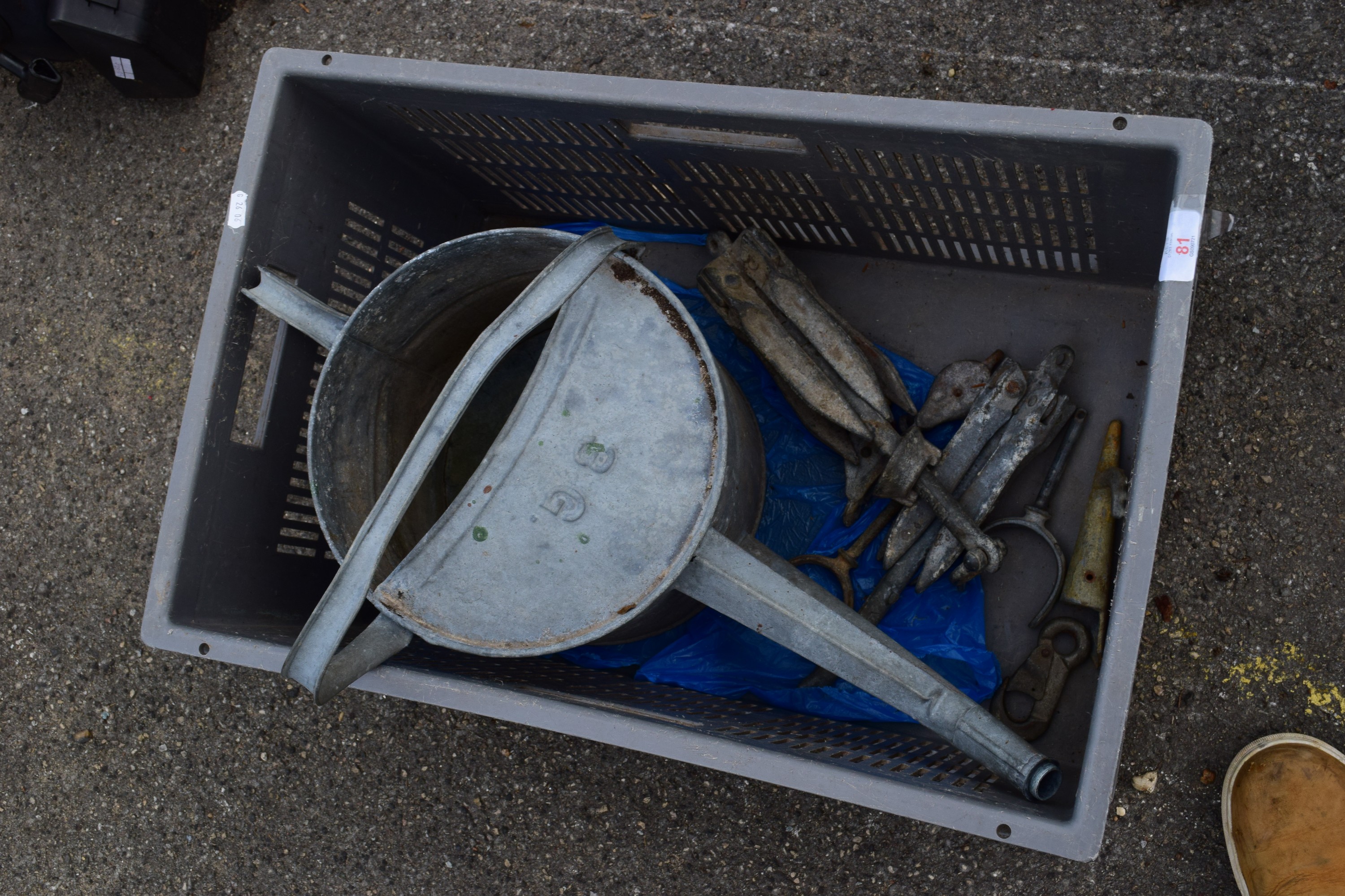 CRATE CONTAINING GALVANISED WATERING CAN AND A PAIR OF BOAT ANCHORS