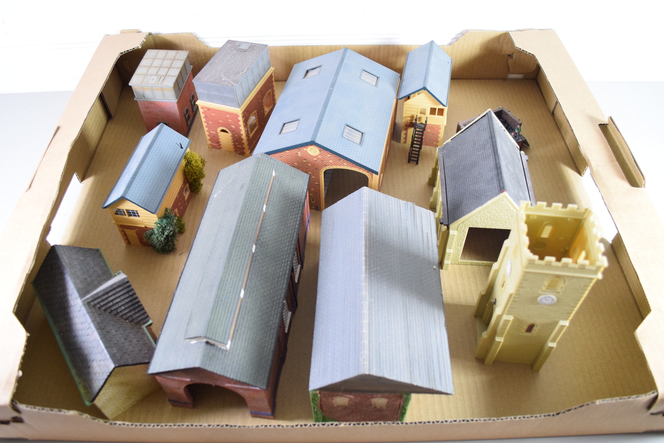 Group of resin and plastic models of buildings to include engine shed, water tower, church etc