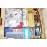 Tray containing model railway diorama items including packaged insulation sleeves, wiring,
