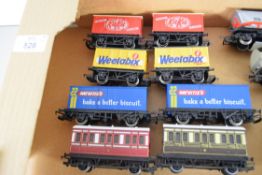 Group of eight unboxed 00 gauge advert branded wagons plus two carriages, various makers