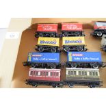 Group of eight unboxed 00 gauge advert branded wagons plus two carriages, various makers