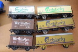 Group of six unboxed 00 gauge goods wagons to include Carlsberg branded etc