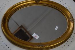 SMALL OVAL GILT FRAMED MIRROR, APPROX 47 X 36CM