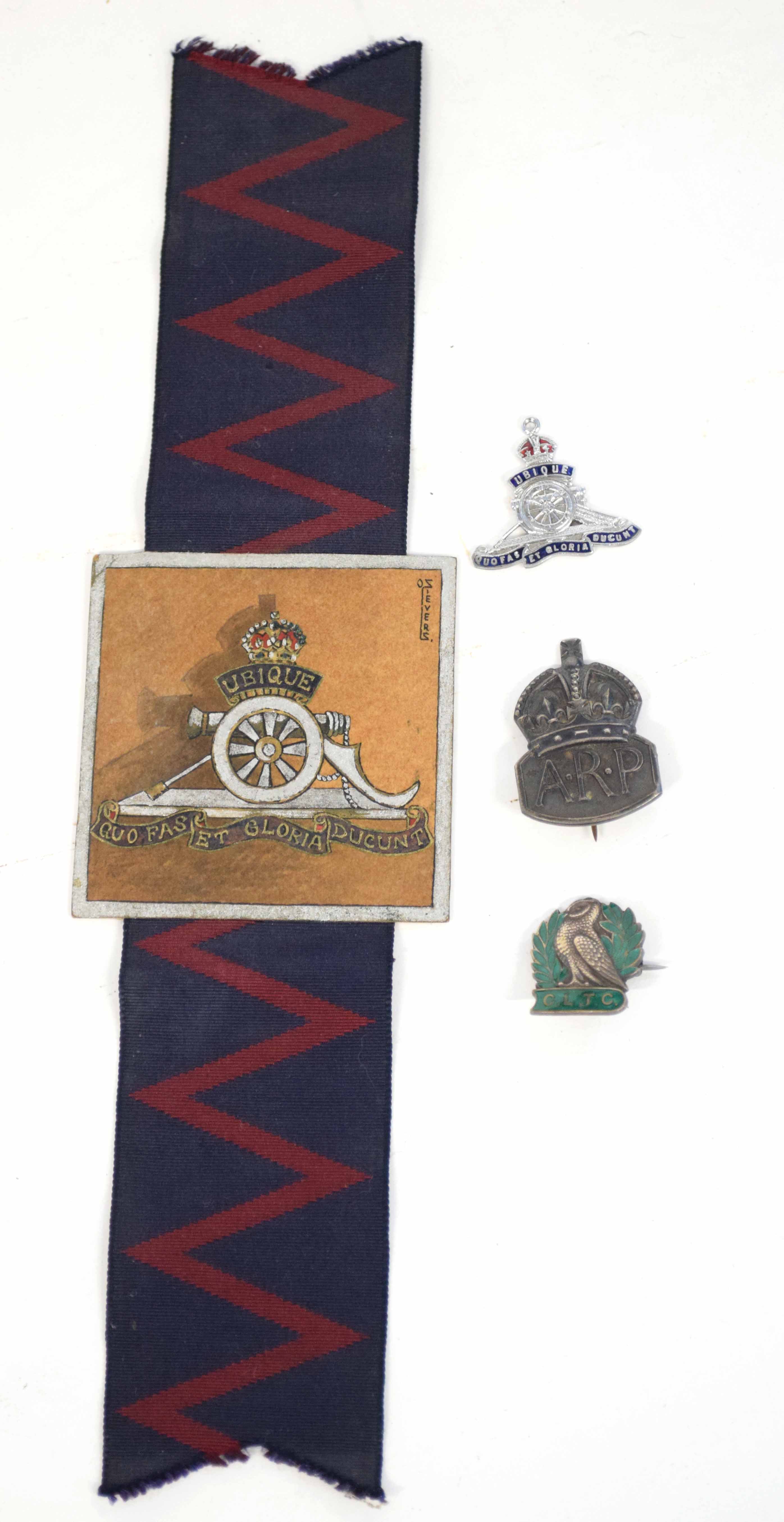 Small selection of insignia and badges to include painted insignia of Royal Artillery with flash