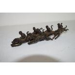 Group of monkey jockeys, metal models with monkeys astride racing dogs, 18cm long