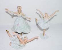 Group of three ballet dancers in various poses