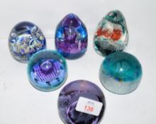 Group of paperweights including a Caithness Atlantis limited edition 1389/1500, Caithness Five