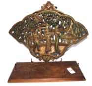 Carved Oriental coat rack together with a further carved wooden plaque with Oriental figures in a