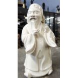 Unusual white pottery glazed figure of a Chinese deity, 15cm high