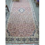 Caucasian runner on a red field, geometric pattern, blue and white decorated triple border (faded)