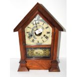 Clock in mahogany case, decorated to front with a military scene of cannon and crossed swords