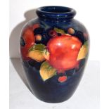Moorcroft vase decorated in the pomegranate pattern, green WM signature to base