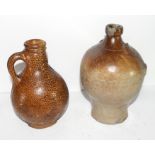 Late 17th/early 18th century globular pottery jug of Bellarmine type with orange peel glaze,