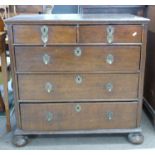 18th century oak chest of two short over three long drawers, raised on bun feet with decorative