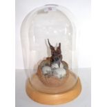 Ceramic sculpture of a baby dragon coming out of an egg, the sculpture under a glass dome, 36cm