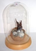 Ceramic sculpture of a baby dragon coming out of an egg, the sculpture under a glass dome, 36cm