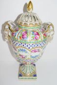 Large Continental porcelain vase with pierced decoration and floral swags and rams-head handles, the