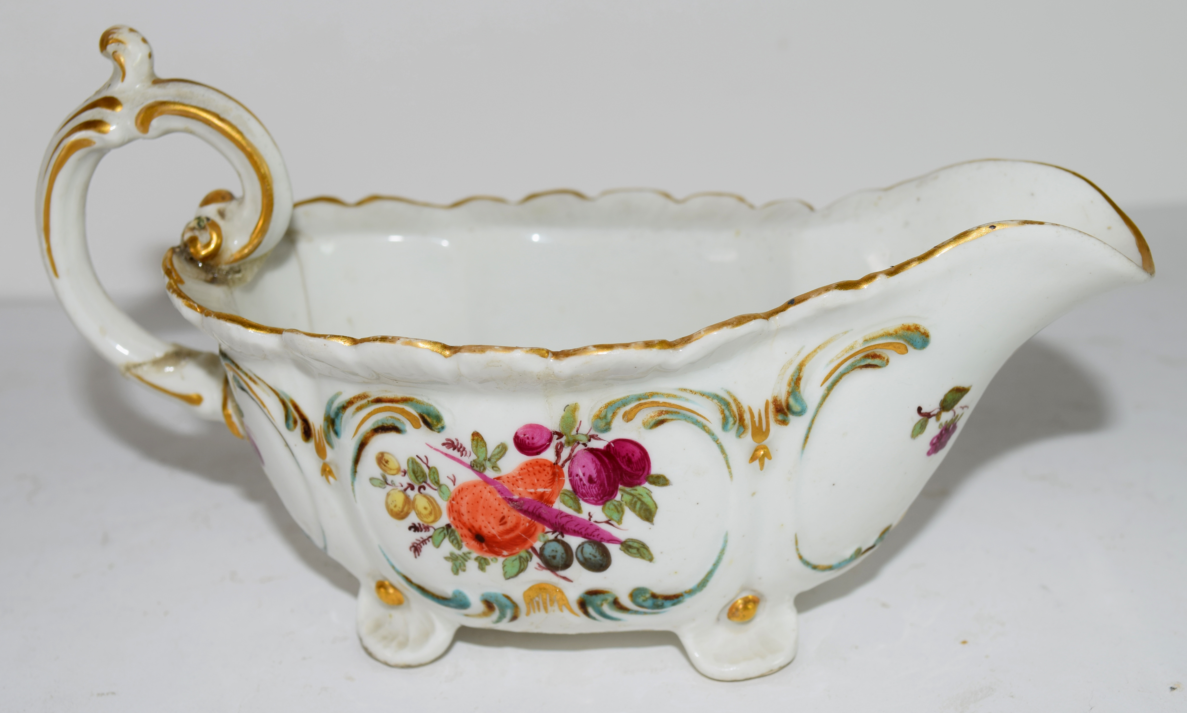 Chelsea Porcelain sauce boat decorated with fruit, gold anchor period (extensively damaged and