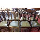 Set of eight (6+2) leather upholstered dining chairs with carved decoration