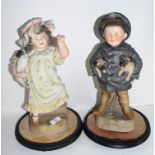 Pair of late 19th century Continental bisque figures of a boy and girl, possibly Russian, both