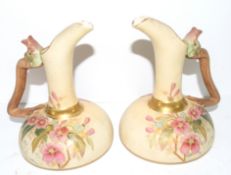 Pair of Continental ewers modelled in Royal Worcester style with the blush ground with floral