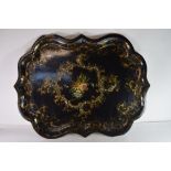 Large shaped papier mache tray with central decoration of flowers within scrolling gilt borders,