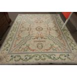 Woolwork carpet, cream ground, pink and green designs, green foliate scroll border 10 x 8ft