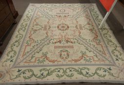 Woolwork carpet, cream ground, pink and green designs, green foliate scroll border 10 x 8ft