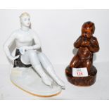 Continental porcelain Art Deco style model of a lady together with a further carved wooden example