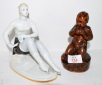 Continental porcelain Art Deco style model of a lady together with a further carved wooden example