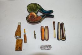 Quantity of pipes, one in original leather case with carved wooden bowl and carved shell type