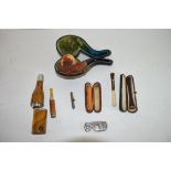 Quantity of pipes, one in original leather case with carved wooden bowl and carved shell type