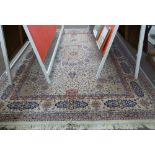 Wool carpet, beige coloured ground, blue and foliate pattern, gulled border, 12 x 9ft