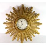 Eight day sunburst clock with typical metal design