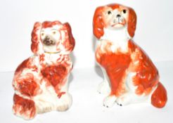 Two Staffordshire dogs with red decoration in typical fashion