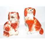 Two Staffordshire dogs with red decoration in typical fashion