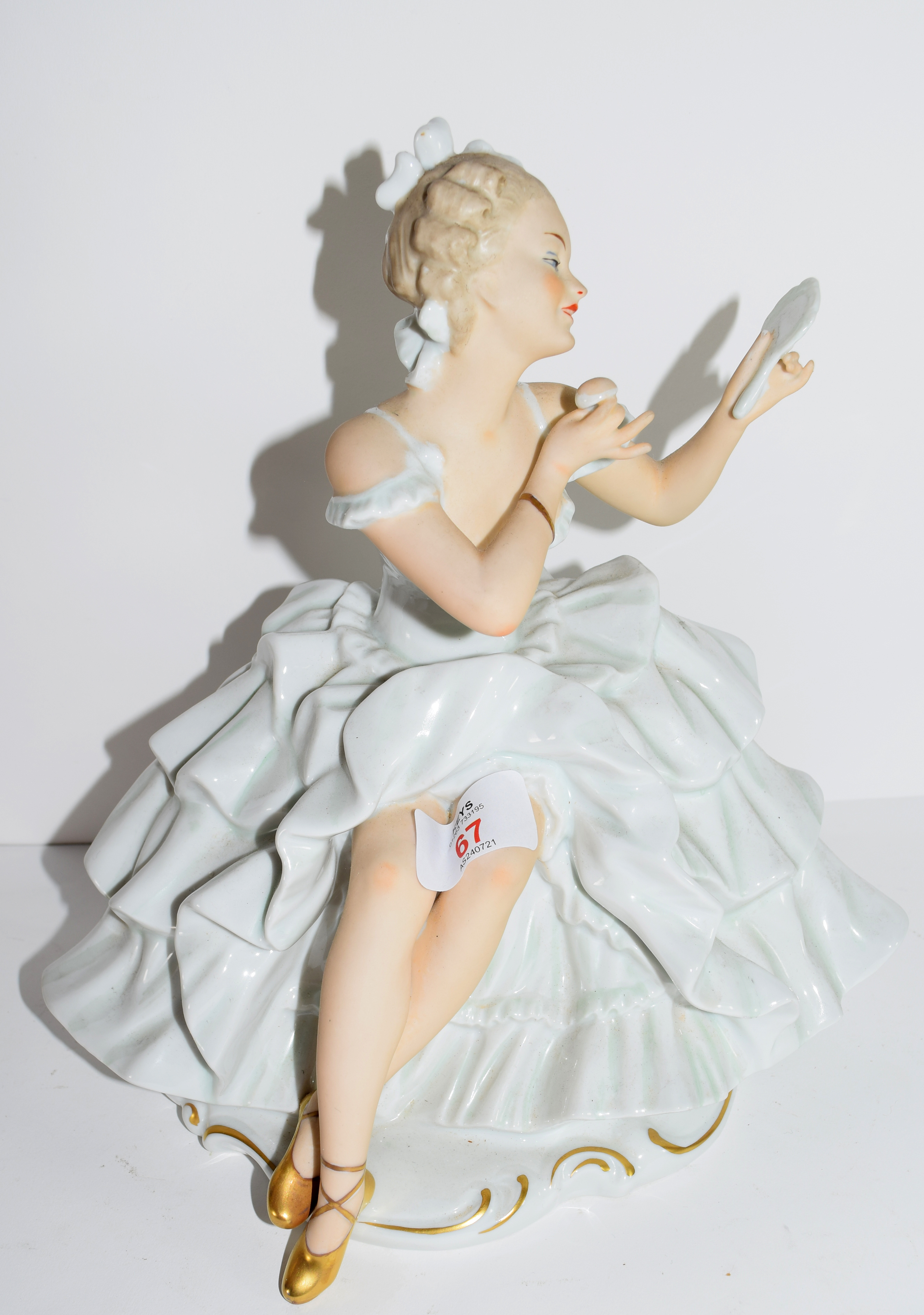 Continental porcelain model of a seated ballerina, 27cm high