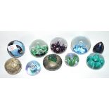 Group of paperweights, some aquamarine Isle of Wight glass, Caithness moonflower plus one other