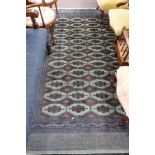 Green and Brown patterned wool carpet, decorated with medallions and a gulled border, 9ft x 5ft8