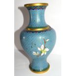 Cloisonne vase decorated in typical fashion with flowers on blue and gilt ground, 23cm high