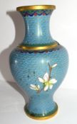 Cloisonne vase decorated in typical fashion with flowers on blue and gilt ground, 23cm high